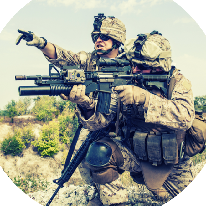 Photo of two soldiers with one holding a gun and another soldier pointing at distance. Powering Gunshot Detection Systems provided by Winchester Interconnect